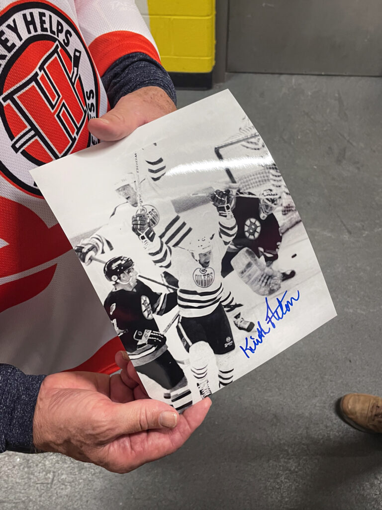 A close photograph showing a Keith Actons hands holding a black and white photograph of him from the 1988 Stanley Cup final.