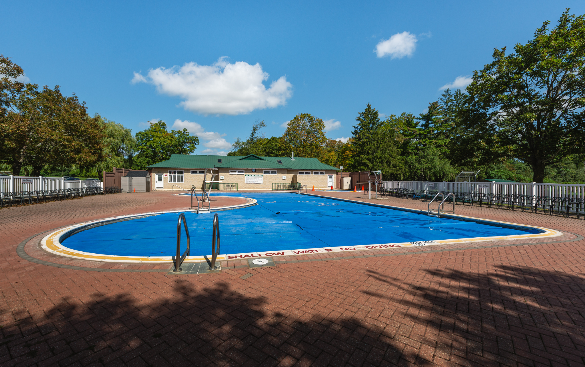 Simeon Park - Outdoor Pool A photograph showing the outdoor pool and deck area at midday in Simeon Park.