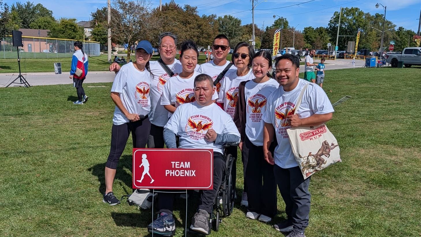 A photograph showing Kevin Lie seated and surrounded by his run team at the Stouffville Terry Fox Run.